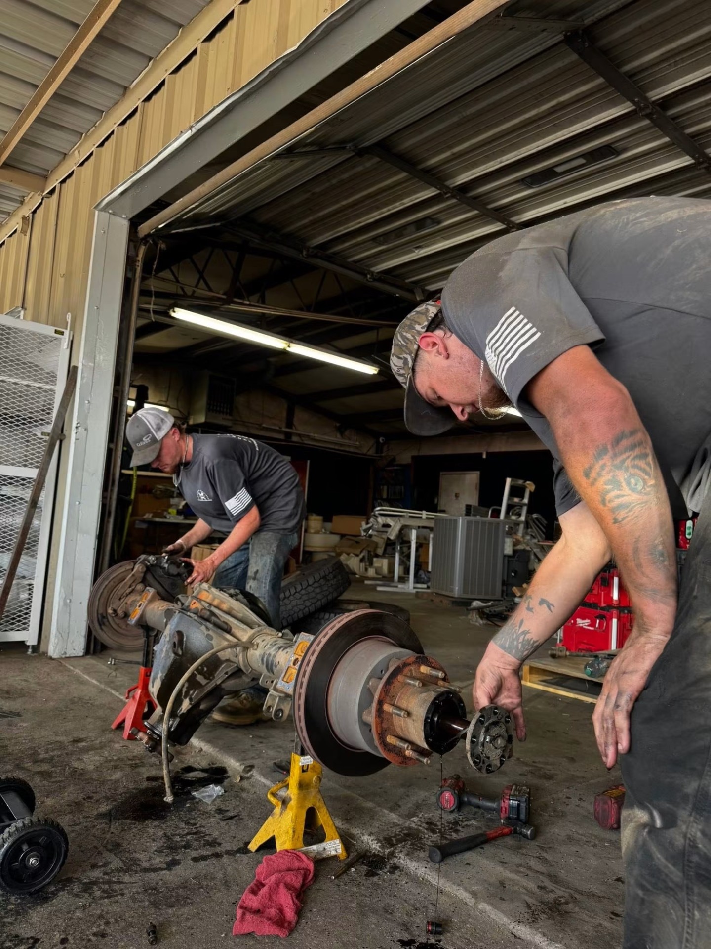 Gunnells Services techs working on a heavy-duty front axle in the shop